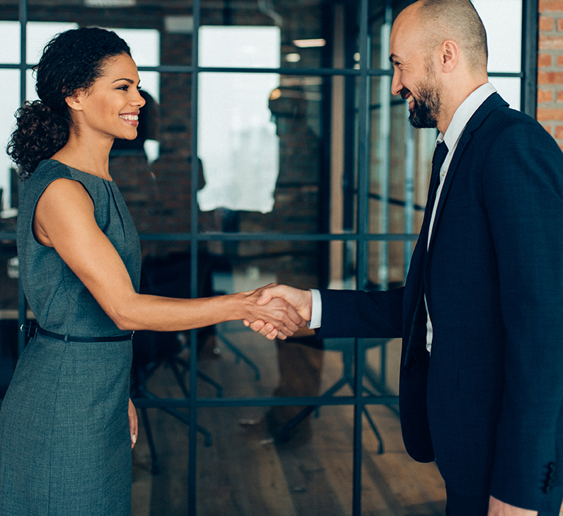 Business people smiling and shaking hands