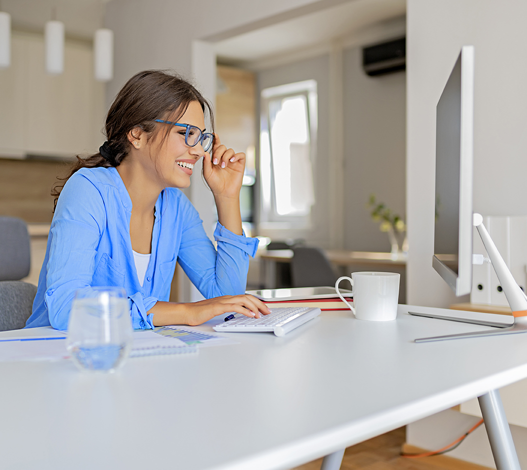 woman working at computer in her kitchen